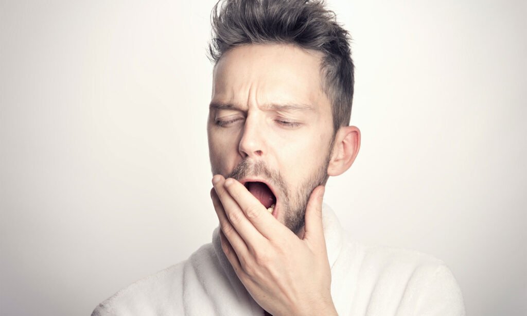 Man yawning with tiredness.