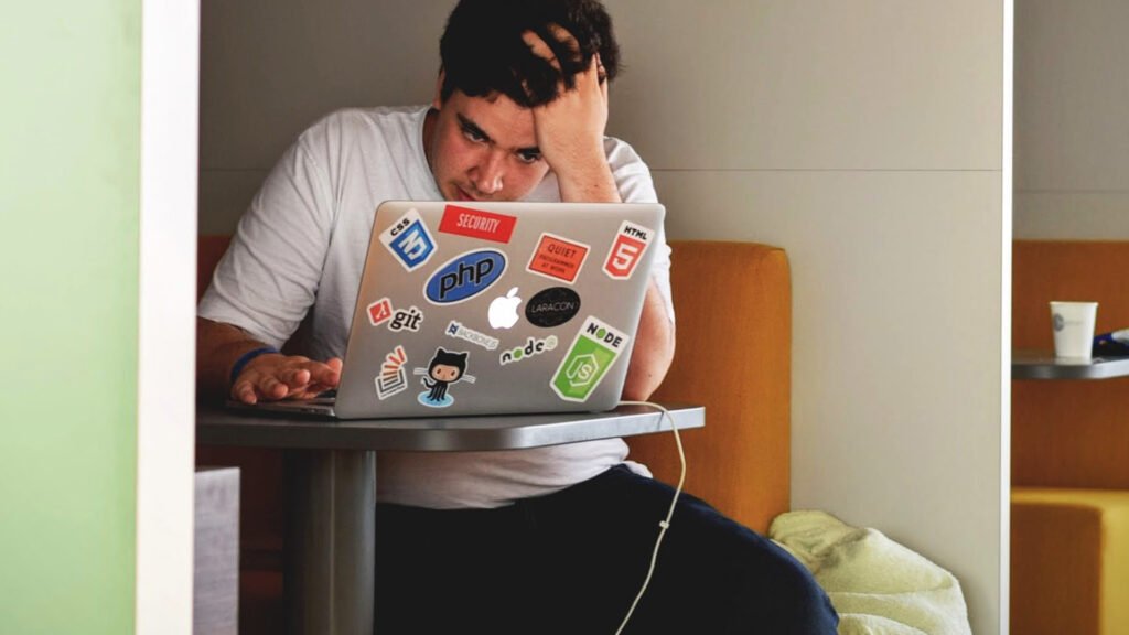 Stressed man using a laptop